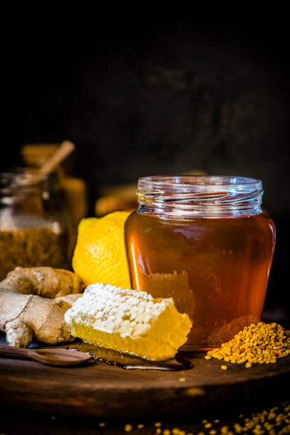 Honey jar with honeycomb and bee pollen, ginger and lime