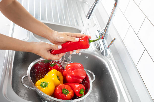 istock Washing Peppers Under Running Water 1173789504
