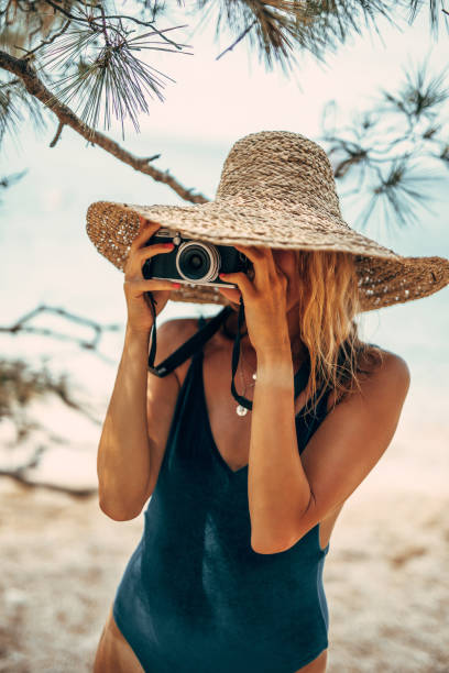 istock Woman taking photo on the beach 1173790705