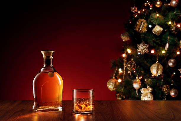 santa drink close up view  of glass with whiskey on color back glass of bourbon stock pictures, royalty-free photos & images
