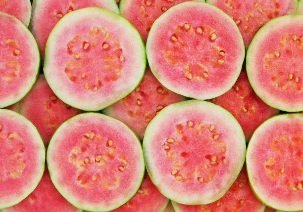 Pink guava background Pink guava slices as background guava stock pictures, royalty-free photos & images