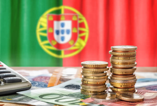 Euro banknotes and coins in front of the national flag of Portugal Euro banknotes and coins in front of the national flag of Portugal german flag photos stock pictures, royalty-free photos & images