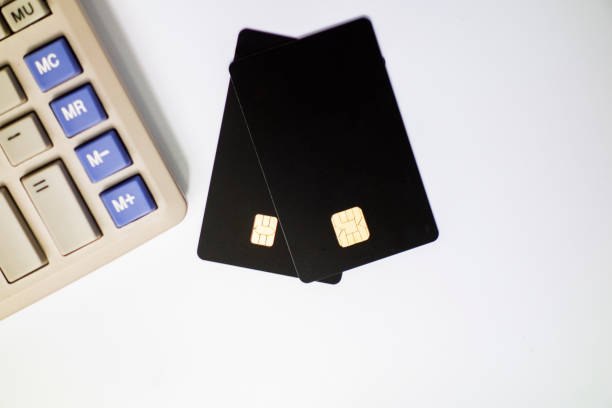 istock Calculators and bank cards in a white background 1173800984