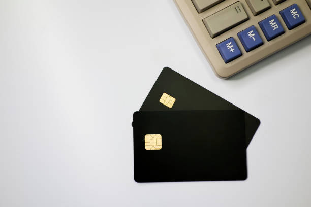 istock Calculators and bank cards in a white background 1173801080