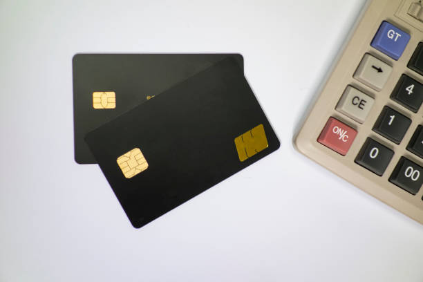istock Calculators and bank cards in a white background 1173801081