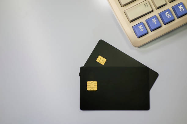 istock Calculators and bank cards in a white background 1173801130