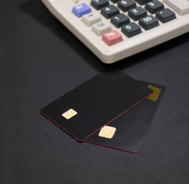 istock Bank cards and calculators in a black background 1173801209