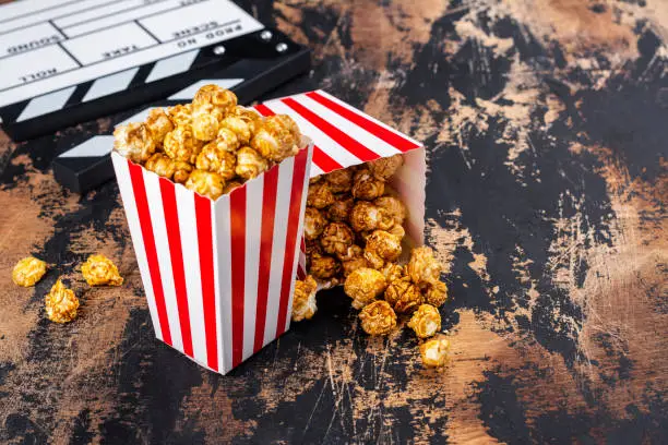 Photo of Caramel popcorn and wooden clapper