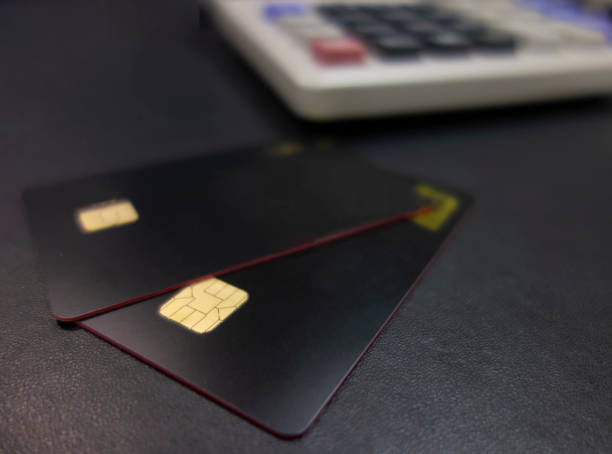 istock Bank cards and calculators in a black background 1173801254
