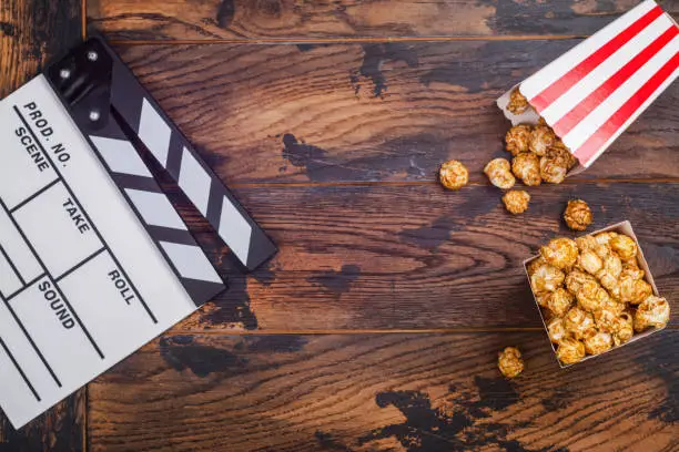 Photo of Caramel popcorn and wooden clapper