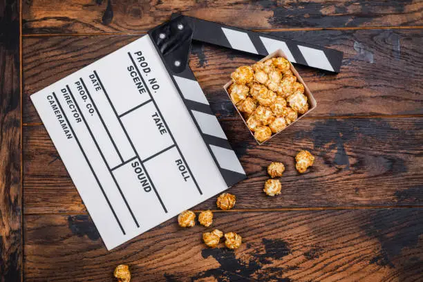 Photo of Caramel popcorn and wooden clapper