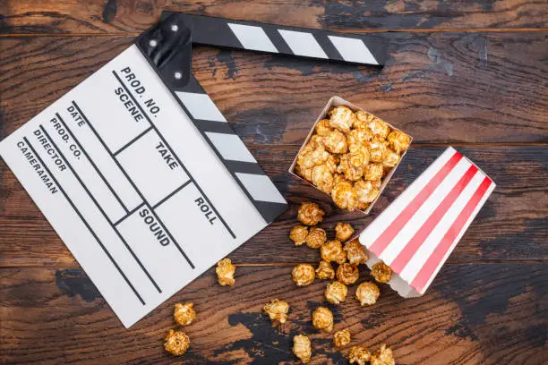 Photo of Caramel popcorn and wooden clapper