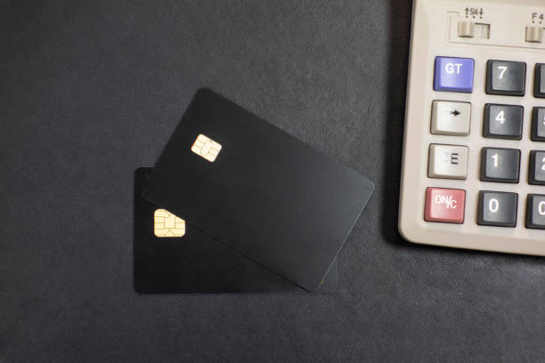istock Bank cards and calculators in a black background 1173801342