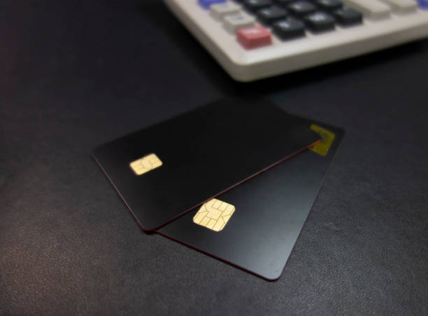 istock Bank cards and calculators in a black background 1173801345