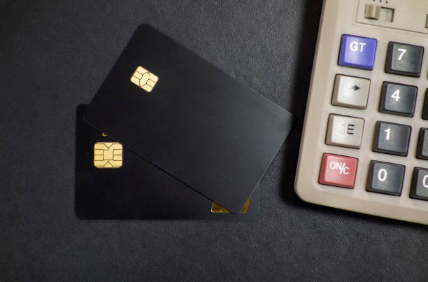 istock Bank cards and calculators in a black background 1173801355