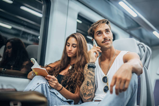 istock Young couple riding in subway train together 1173801777