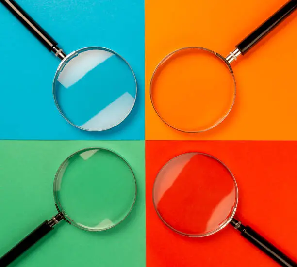 Four magnifying glass on the four colour background. Template for a SWOT analysis.