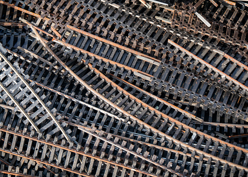 Sections of model railway track for sale on a market stall at the weekly market in Fakenham in Norfolk, England; some are straight, some curved.