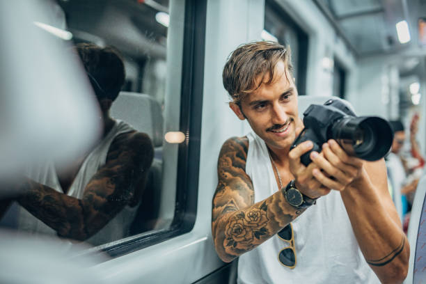 istock Man photographer riding in subway train 1173803898