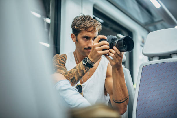 istock Photographer riding in subway train 1173803964