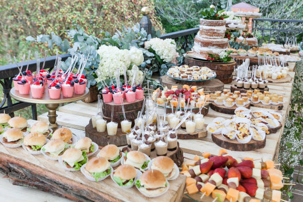 istock Table decorated with desserts, snacks and cake - wedding reception for event guests. 1173804858