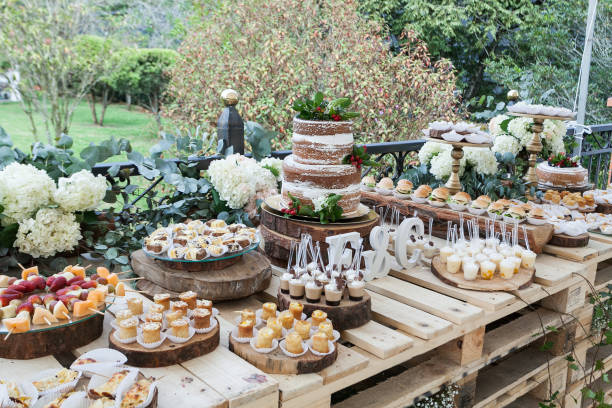 istock Table decorated with desserts, snacks and cake - wedding reception for event guests. 1173804962