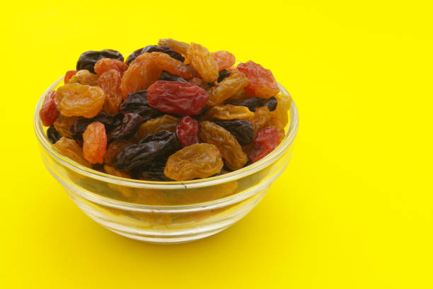istock Raisins in bowl on yellow background 1173808849