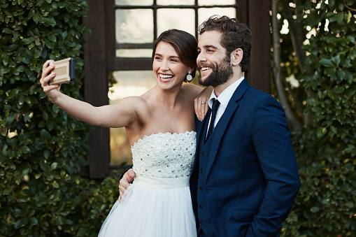 Cropped shot of a happy middle aged couple taking a selfie on their wedding day