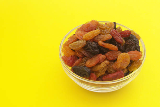 istock Raisins in bowl on yellow background 1173809995