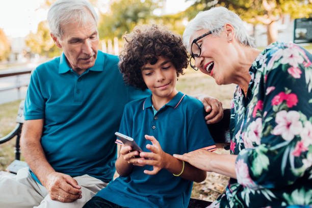 istock Grandparents looking at grandson's phone 1173810025