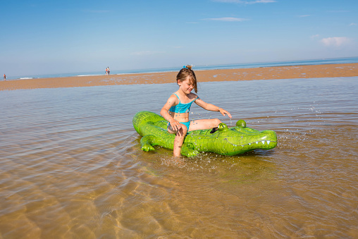 pretty girl and her inflatable games in the sea