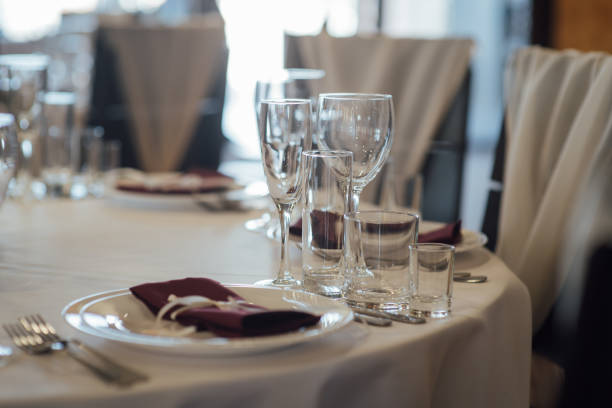 istock Glasses, flower fork, knife served for dinner in restaurant with cozy interior 1173812734