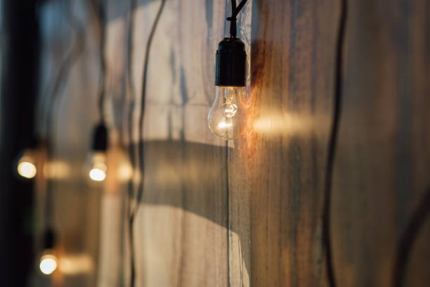 istock Light bulb decor at wall in outdoor party 1173812896
