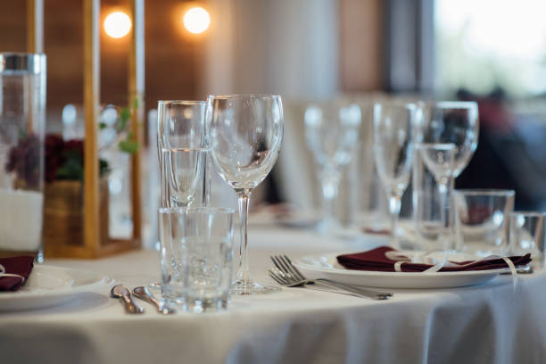 istock Glasses, flower fork, knife served for dinner in restaurant with cozy interior 1173814147