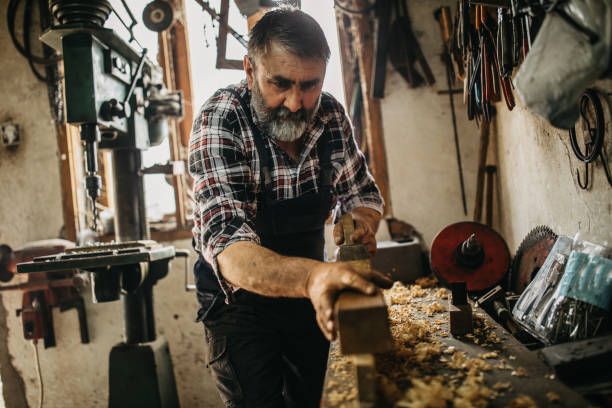 istock Senior man working on cutting wood 1173816465