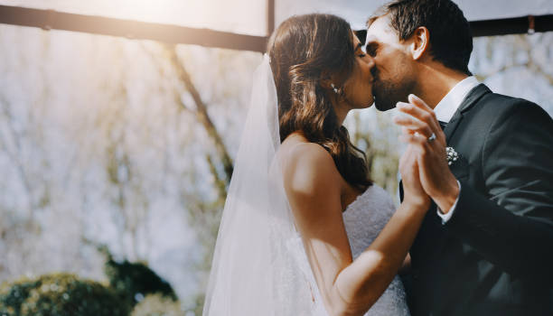 Cropped shot of an affectionate young newlywed couple kissing on their wedding day