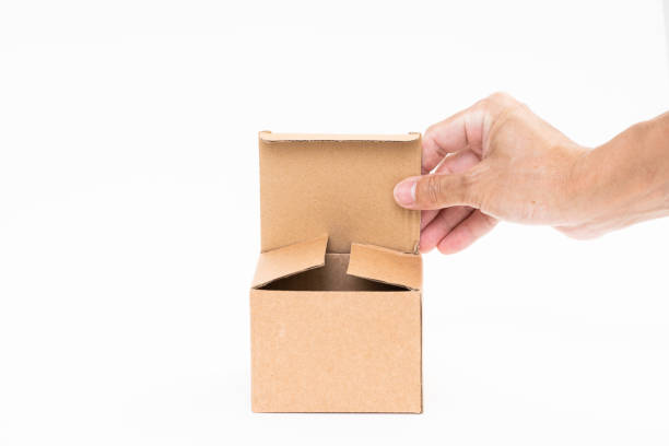 istock Man hand holding brown paper box on white background 1173819501
