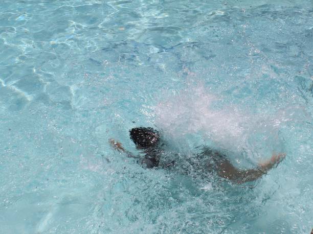 istock boy swimming in a pool of fresh water 1173819800