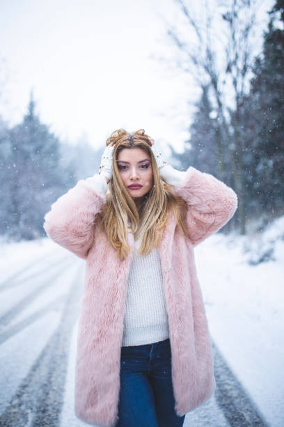 istock woman having fun in snow 1173820676