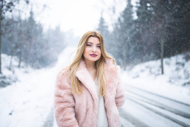 istock woman having fun in snow 1173820683