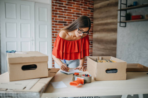 istock Young woman fulfilling online order 1173820899