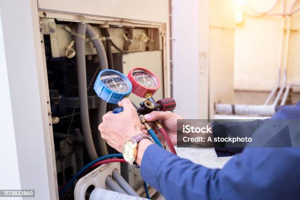 Technician Is Checking Air Conditioner Measuring Equipment For Filling Air Conditioners Stock Photo - Download Image Now