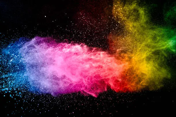 Photo of Colorful background of pastel powder.Multi colored dust splash on black background.Painted Holi.