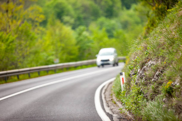 istock Driving into Low Visibility right curve street lane 1173825212