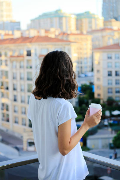 istock Woman hand holding coffee paper drinking cup 1173826129