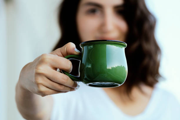 istock Woman hand holding coffee drinking cup 1173826352