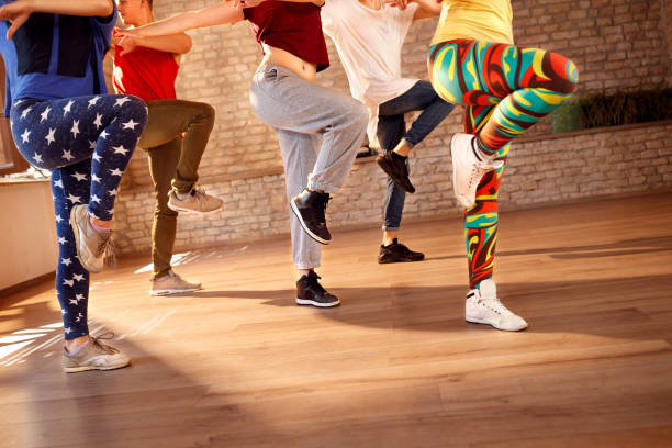 Dancers on pause from dancing looking on cell phone