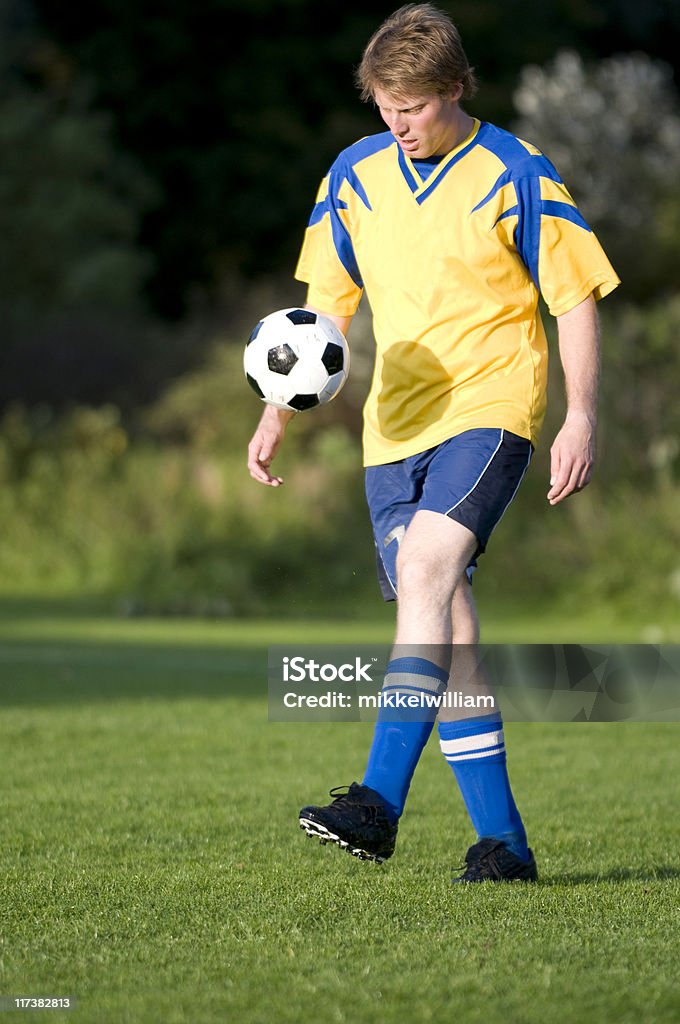 Jogador de futebol com uma bola de futebol faz malabarismo com - Foto de stock de Atacante de futebol royalty-free