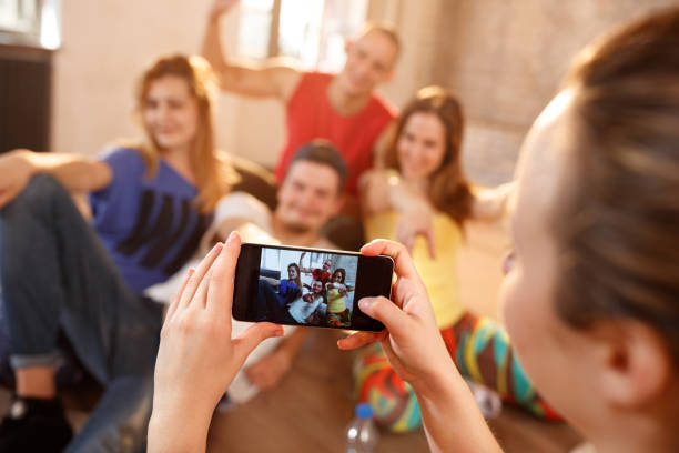 istock Dancers on pause from dancing looking on cell phone 1173828873