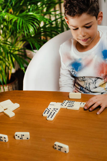 istock School boy playing dominoes 1173830151